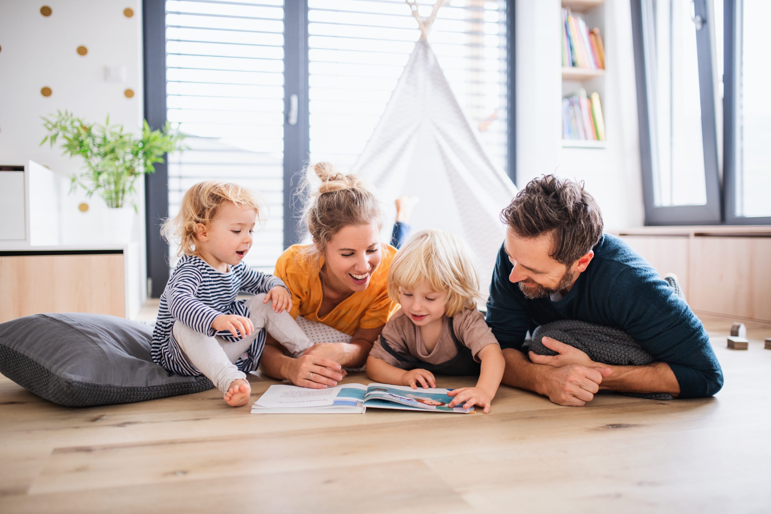 family reading a magazine on the floor